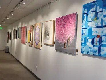 A second view of paintings along the gallery wall