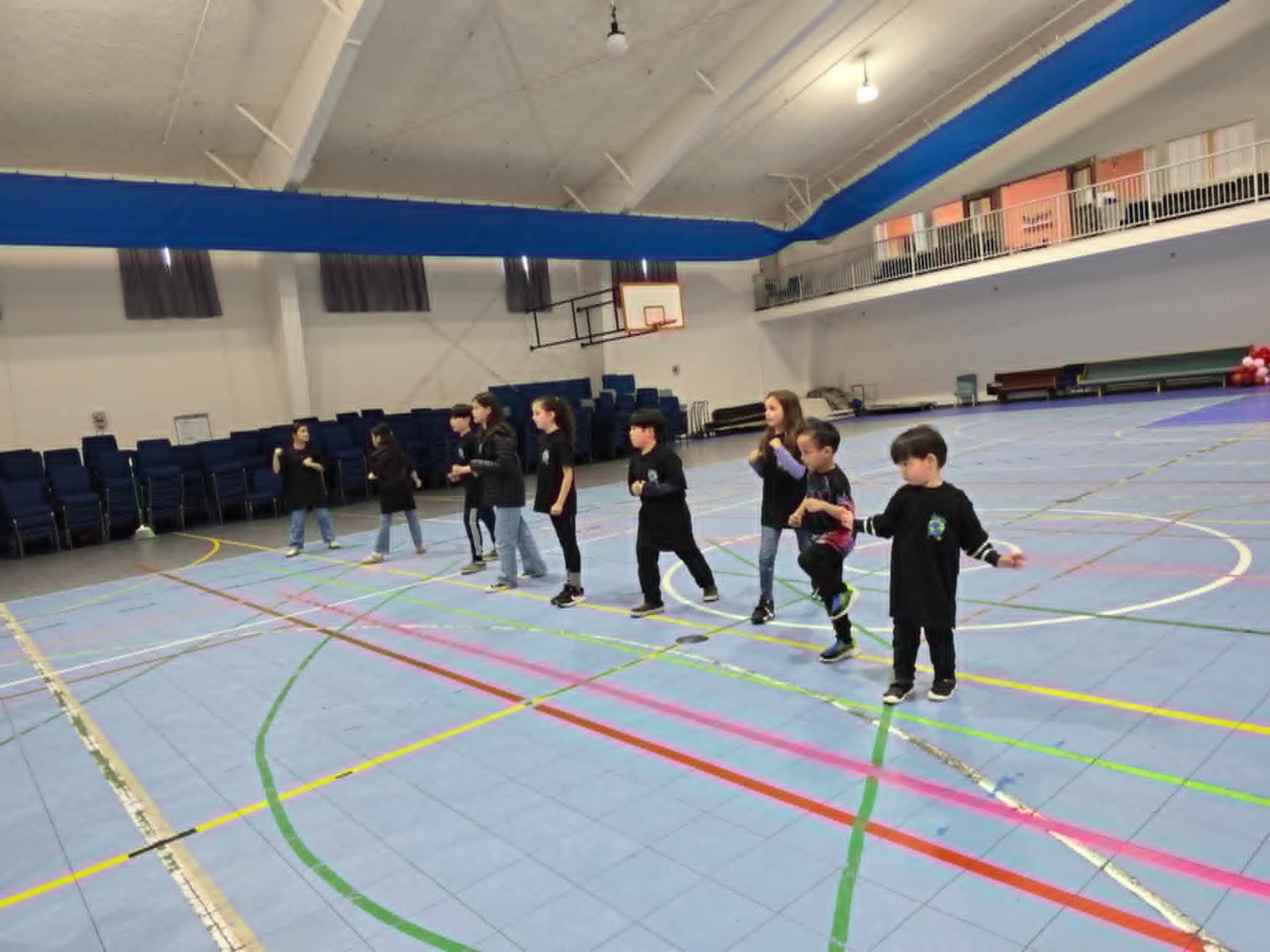 Children run across the gym floor