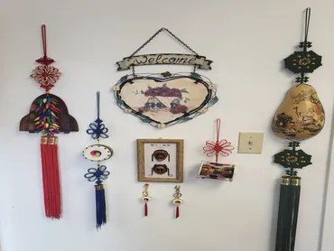 Traditional Korean hangings and a welcome sign on a wall